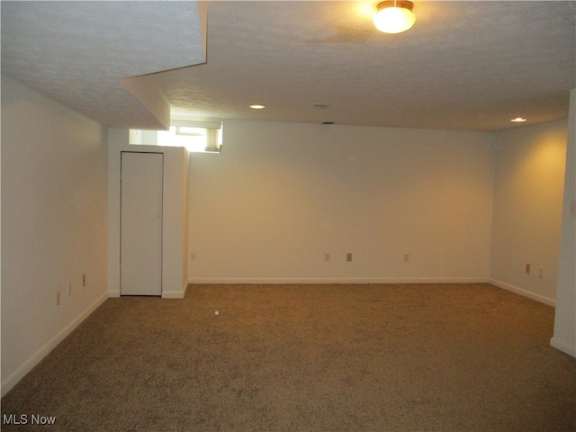 basement with a textured ceiling and carpet floors