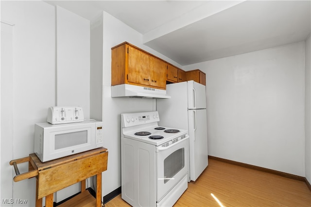 kitchen featuring light wood-type flooring and white appliances