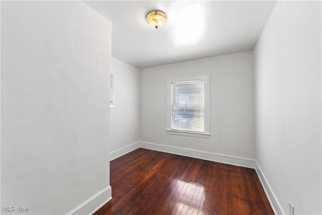 empty room with dark wood-type flooring