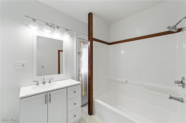 bathroom with tile patterned floors, washtub / shower combination, and vanity