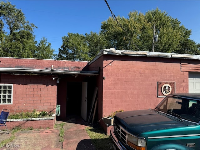 view of property exterior with a garage and a carport