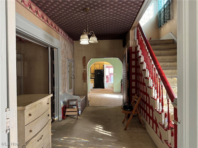 hallway featuring a chandelier