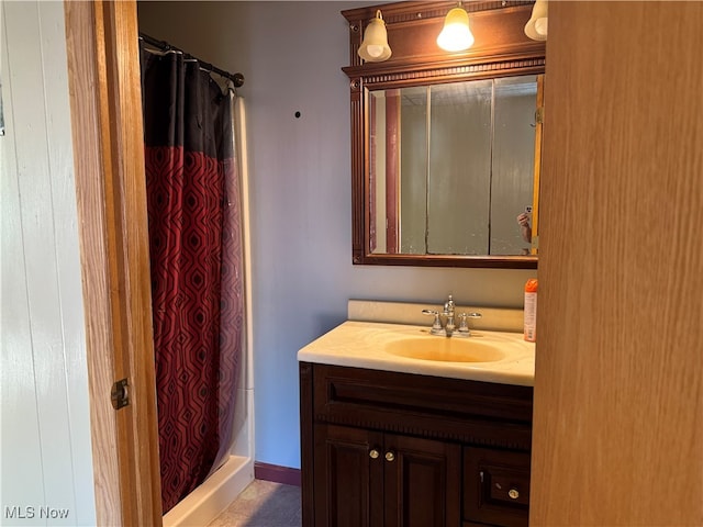 bathroom featuring vanity and a shower with shower curtain