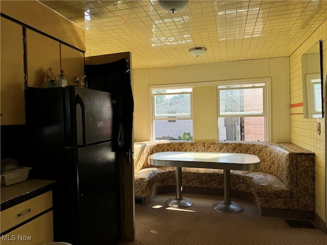 kitchen featuring black refrigerator