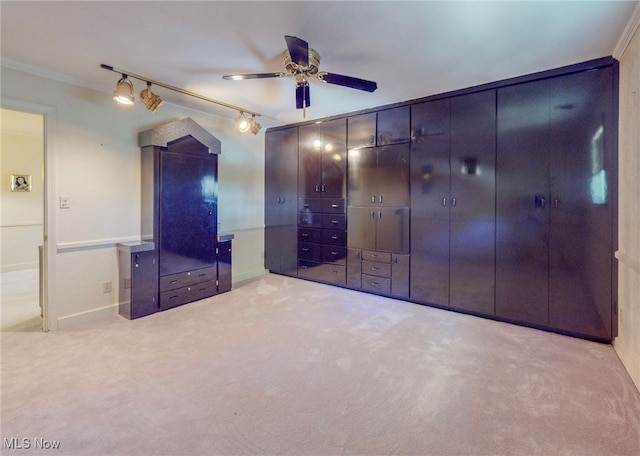 unfurnished bedroom featuring light colored carpet, crown molding, and ceiling fan