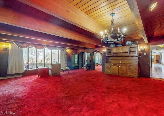 unfurnished living room with wooden ceiling, beamed ceiling, a notable chandelier, and carpet floors