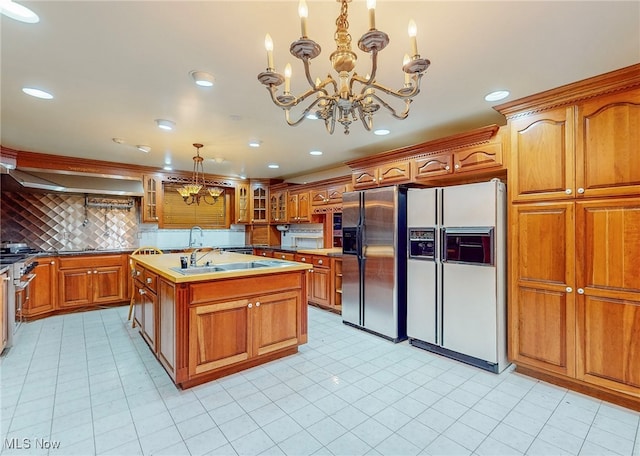 kitchen with backsplash, an inviting chandelier, a center island, stainless steel fridge with ice dispenser, and wall chimney range hood