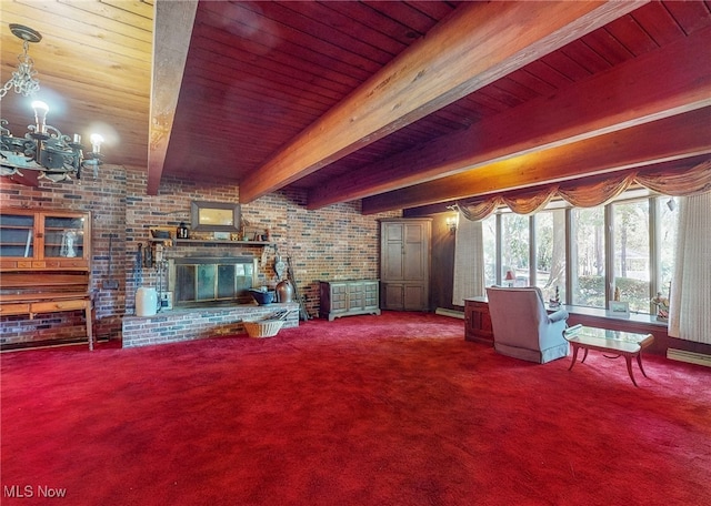 carpeted living room featuring brick wall, beamed ceiling, a fireplace, a notable chandelier, and wood ceiling