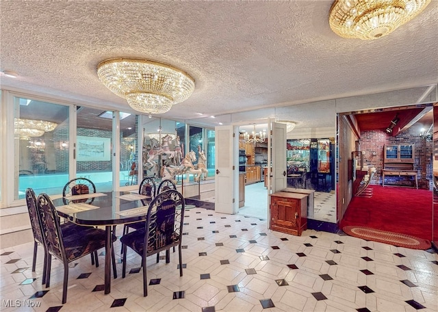 dining room with brick wall, a notable chandelier, and a textured ceiling