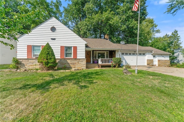 view of front of home featuring a porch, a front yard, and a garage