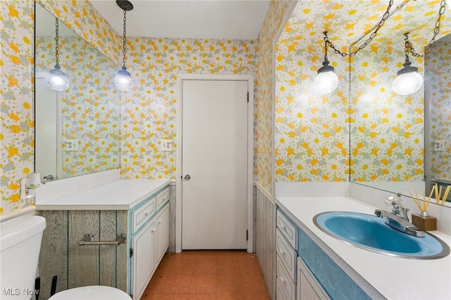 bathroom featuring tile patterned floors, toilet, and vanity