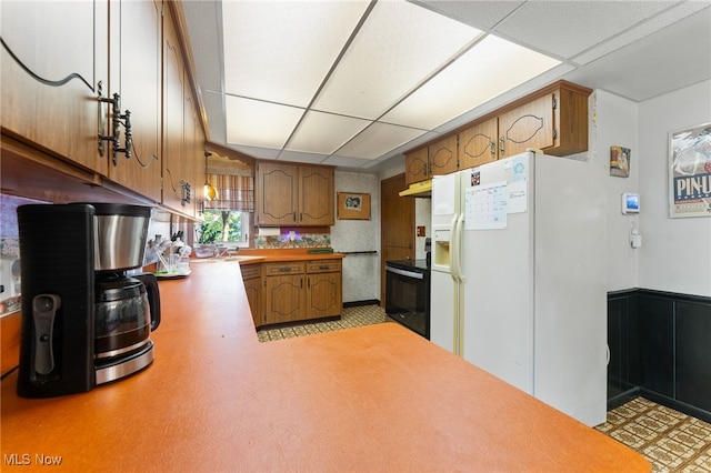 kitchen with black appliances and a paneled ceiling