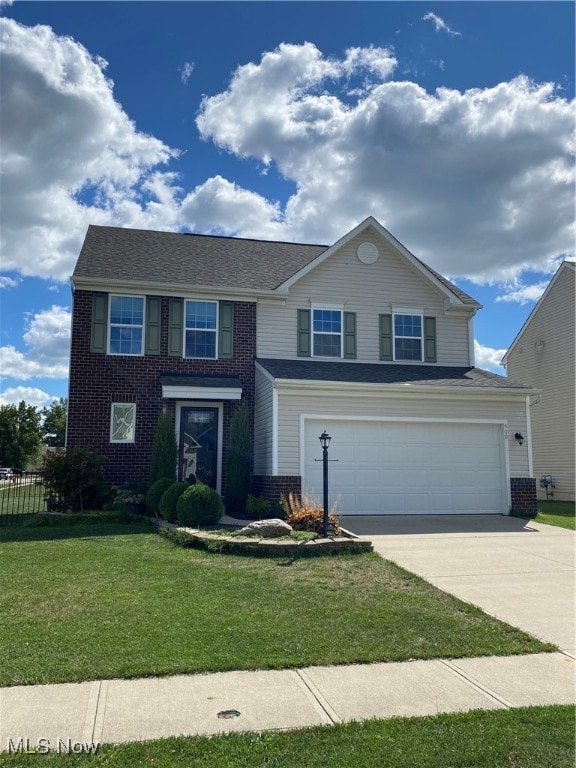 view of front of house featuring a front lawn and a garage