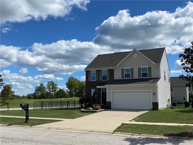 view of front of house featuring a garage and a front lawn