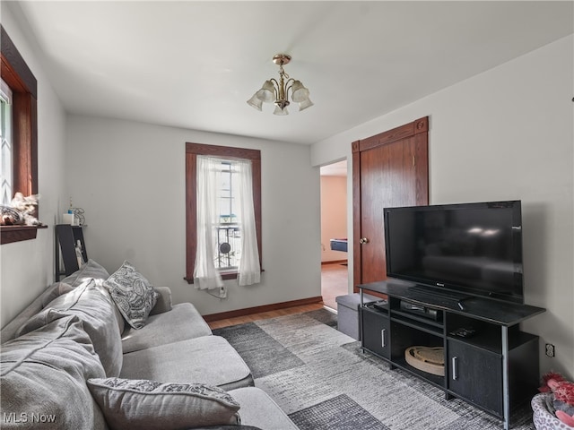 living room with hardwood / wood-style flooring and a chandelier