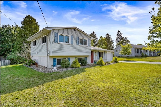 tri-level home with a front yard