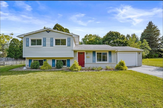 split level home with a garage and a front lawn