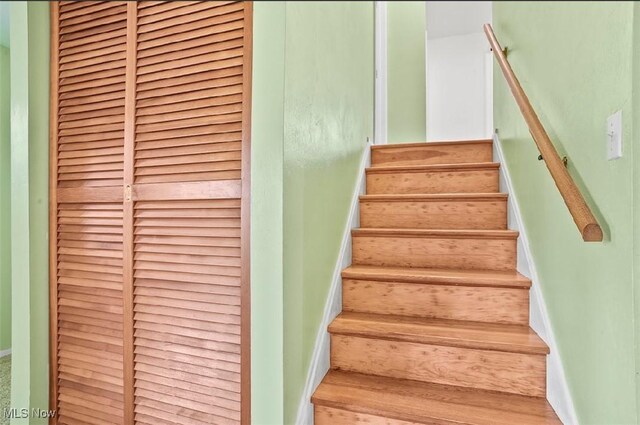 stairs featuring wood-type flooring