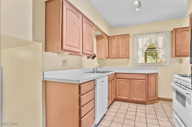 kitchen with rail lighting, white appliances, light tile patterned flooring, and sink