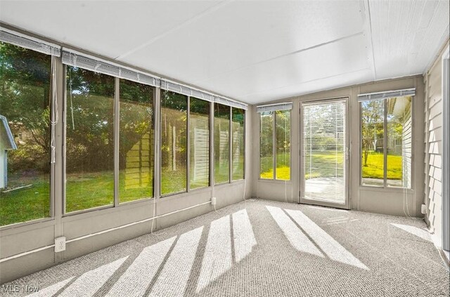 unfurnished sunroom with plenty of natural light and vaulted ceiling