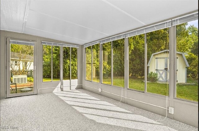 unfurnished sunroom with lofted ceiling