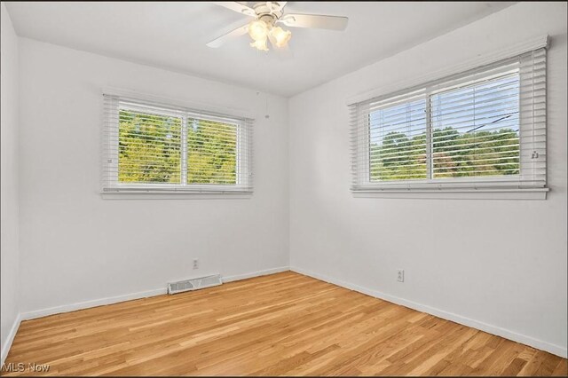 spare room with ceiling fan and light hardwood / wood-style flooring