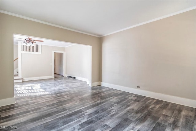 empty room featuring a ceiling fan, ornamental molding, stairway, and wood finished floors