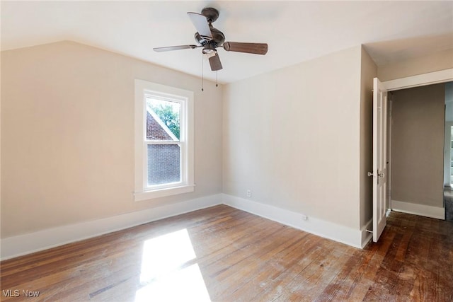 unfurnished room featuring wood-type flooring, a ceiling fan, baseboards, and lofted ceiling