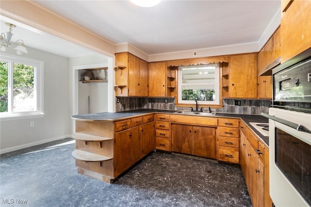 kitchen with backsplash, a sink, open shelves, and brown cabinets