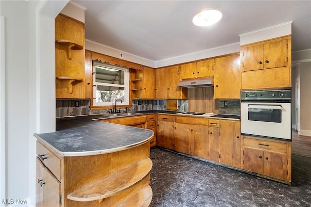 kitchen with a sink, open shelves, brown cabinetry, under cabinet range hood, and white appliances