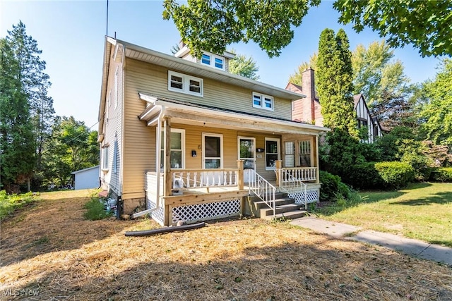 traditional style home with a porch and a front lawn