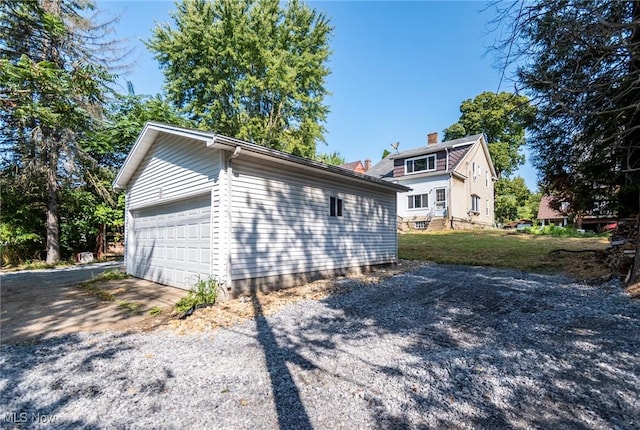 view of side of home with a garage and an outdoor structure