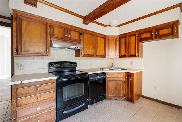 kitchen featuring light countertops, backsplash, a sink, under cabinet range hood, and black appliances