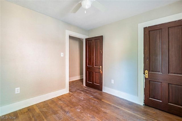 empty room with baseboards, hardwood / wood-style flooring, and a ceiling fan