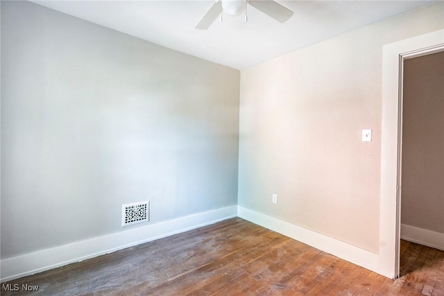 unfurnished room featuring baseboards, visible vents, ceiling fan, and wood-type flooring