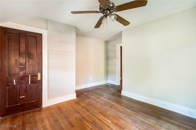 unfurnished room with baseboards, lofted ceiling, ceiling fan, and wood-type flooring