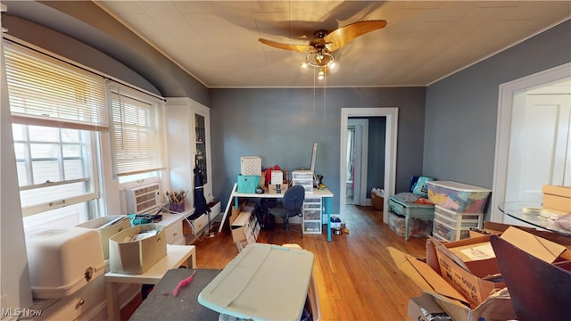 office area featuring crown molding, hardwood / wood-style floors, and ceiling fan