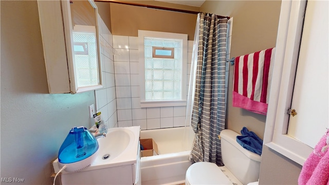 full bathroom with vanity, toilet, and shower / bath combination with curtain