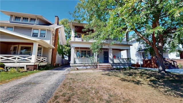 view of front of home featuring a front yard and a porch