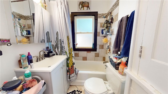 full bathroom featuring toilet, sink, tile patterned floors, and shower / bath combo