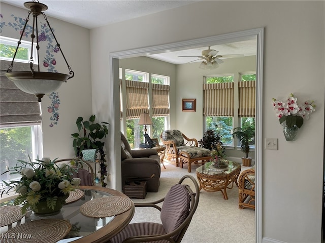 carpeted living room with ceiling fan