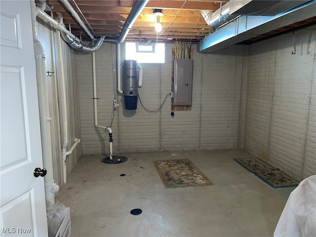 basement featuring electric panel and brick wall