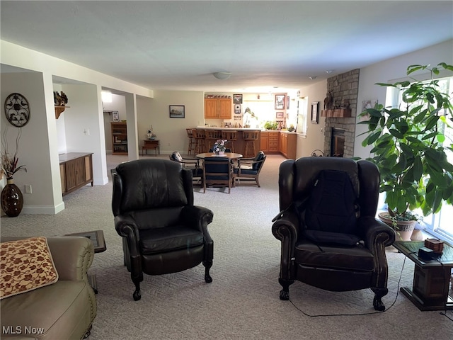 living room featuring a fireplace and carpet floors