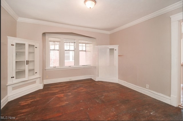 empty room featuring crown molding and dark wood-type flooring