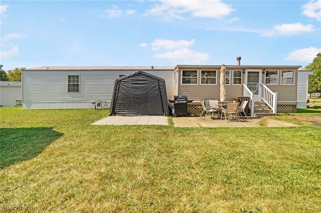 rear view of property with a lawn and a patio area