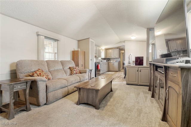 living room with light colored carpet, a textured ceiling, and vaulted ceiling