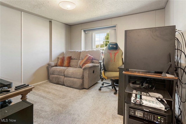 home office with carpet flooring and a textured ceiling