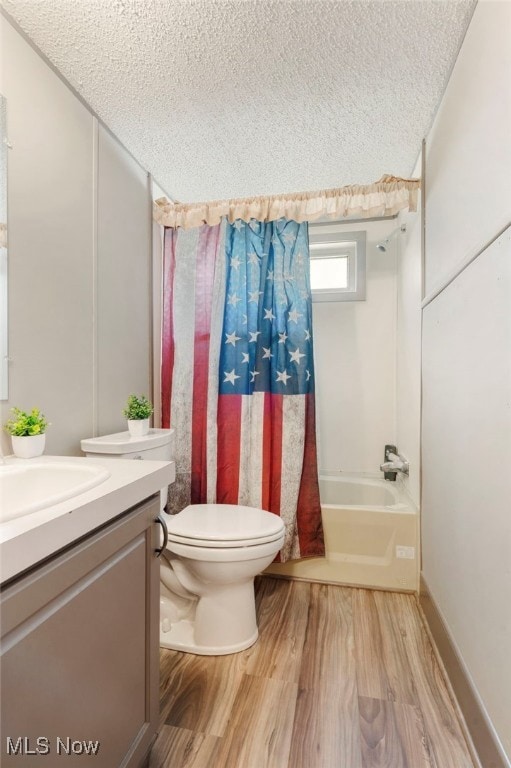 5042 Valley Dr SW, Navarre, OH 44662 - full bathroom featuring toilet, vanity, wood finished floors, shower / bath combination with curtain, and a textured ceiling