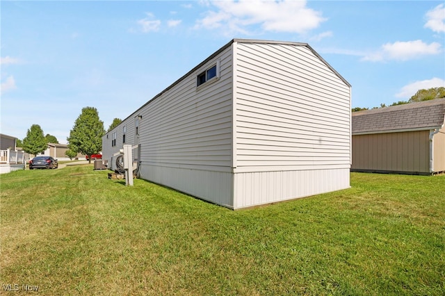 view of side of property featuring a yard and a storage unit