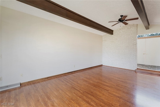 empty room featuring a textured ceiling, ceiling fan, wood-type flooring, and vaulted ceiling with beams